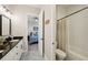 Bathroom with double sink vanity, modern fixtures, toilet, and shower-tub combination at 720 Bay Esplanade, Clearwater Beach, FL 33767