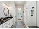 Well-lit bathroom with double vanity, granite countertops, and glass shower at 720 Bay Esplanade, Clearwater Beach, FL 33767