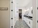 Bathroom with dual vanities, modern lighting, decorative flooring, and walk-in closet view at 720 Bay Esplanade, Clearwater Beach, FL 33767
