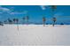 Beautiful white sand beach with a volleyball net and plenty of space for recreation and relaxation under the sun at 720 Bay Esplanade, Clearwater Beach, FL 33767