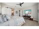 Large, bright bedroom featuring a ceiling fan, a barn door to an en-suite bathroom, and large windows at 720 Bay Esplanade, Clearwater Beach, FL 33767