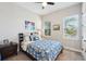 Well-lit bedroom with a ceiling fan, two large windows and neutral carpeting at 720 Bay Esplanade, Clearwater Beach, FL 33767
