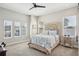 Bright bedroom featuring a carved wooden headboard, ceiling fan, and lots of natural light at 720 Bay Esplanade, Clearwater Beach, FL 33767