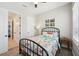 Cozy bedroom with an iron bed frame, ceiling fan and carpeted flooring at 720 Bay Esplanade, Clearwater Beach, FL 33767