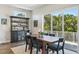 Sun-filled dining room features a large table, a decorative rug, and scenic views through sliding glass doors at 720 Bay Esplanade, Clearwater Beach, FL 33767