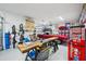 Organized garage featuring a vintage red Mustang, work benches, and plenty of storage at 720 Bay Esplanade, Clearwater Beach, FL 33767