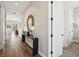 Hallway with wood-look floors, console table with decor, and white doors with black hardware at 720 Bay Esplanade, Clearwater Beach, FL 33767