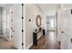 Bright hallway features wood-look flooring, console table with decor, and white doors with black hardware at 720 Bay Esplanade, Clearwater Beach, FL 33767