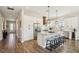Spacious eat-in kitchen featuring granite counters, stainless appliances, an island with bar seating, and white cabinets at 720 Bay Esplanade, Clearwater Beach, FL 33767