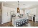 Bright eat-in kitchen featuring granite counters, stainless appliances, an island with bar seating, and white cabinets at 720 Bay Esplanade, Clearwater Beach, FL 33767