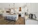 Modern kitchen with white cabinets, granite countertops, and a stylish range hood, creating a bright and inviting space at 720 Bay Esplanade, Clearwater Beach, FL 33767