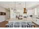 Bright kitchen featuring a large granite island, stainless appliances, an eat-in area, and white cabinets at 720 Bay Esplanade, Clearwater Beach, FL 33767