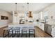 Bright and modern kitchen featuring white cabinetry, stainless steel appliances, and an island with bar seating at 720 Bay Esplanade, Clearwater Beach, FL 33767