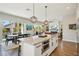 Kitchen island with breakfast bar seating overlooks the dining area and living room in an open-concept layout at 720 Bay Esplanade, Clearwater Beach, FL 33767