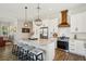 Stylish kitchen with white cabinets, granite countertops, stainless steel appliances, and barstool seating at the island at 720 Bay Esplanade, Clearwater Beach, FL 33767