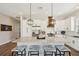 Modern kitchen with island seating, granite countertops, and white cabinets, perfect for cooking and entertaining at 720 Bay Esplanade, Clearwater Beach, FL 33767