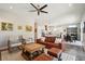 Open-concept living area with a cozy seating arrangement, a modern ceiling fan, and a dining area at 720 Bay Esplanade, Clearwater Beach, FL 33767