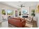 Cozy living room with stylish furniture, electric fireplace, and access to an outdoor balcony at 720 Bay Esplanade, Clearwater Beach, FL 33767