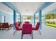 Spacious, blue-walled outdoor seating area with multiple seating arrangements, perfect for entertaining guests at 720 Bay Esplanade, Clearwater Beach, FL 33767