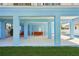 Open blue walled outdoor space with multiple seating areas and views of the pool and backyard at 720 Bay Esplanade, Clearwater Beach, FL 33767