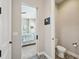 View from bedroom through sliding door to half bathroom featuring stylish tile and toilet at 720 Bay Esplanade, Clearwater Beach, FL 33767