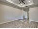 Spacious bedroom with tray ceiling, ceiling fan, recessed lighting and wood-look flooring at 8563 Starlight Loop, Parrish, FL 34219