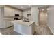 Bright kitchen featuring stainless steel appliances, an island, and light colored cabinetry at 8563 Starlight Loop, Parrish, FL 34219