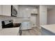 Modern kitchen showcasing quartz countertops, stainless steel appliances, and plenty of cabinet space at 8563 Starlight Loop, Parrish, FL 34219