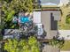Aerial view showcasing a backyard with a pool, manicured lawn, and outdoor seating areas at 9016 Bay Ne St, St Petersburg, FL 33702