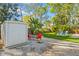 Outdoor storage shed and gravel area with a firepit and seating at 9016 Bay Ne St, St Petersburg, FL 33702
