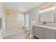 Modern bathroom with double vanity and a walk-in shower with glass accents at 9016 Bay Ne St, St Petersburg, FL 33702