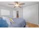 Bright bedroom featuring tile floors, a ceiling fan, and a closet at 9016 Bay Ne St, St Petersburg, FL 33702