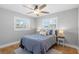 Cozy bedroom with natural light, tile floors, and a ceiling fan at 9016 Bay Ne St, St Petersburg, FL 33702