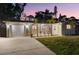 Charming single-story home featuring a well-maintained lawn, attached garage, and lovely landscaping at 9016 Bay Ne St, St Petersburg, FL 33702