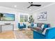 Comfortable living room showcasing stylish furniture, a ceiling fan, and a large TV at 9016 Bay Ne St, St Petersburg, FL 33702