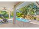 Relaxing outdoor pool with sun loungers, lush tropical landscaping, and patio area at 9016 Bay Ne St, St Petersburg, FL 33702