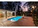 Inviting backyard pool area with tiki torches, lounge chairs, and a cozy fire pit perfect for evening relaxation at 9016 Bay Ne St, St Petersburg, FL 33702