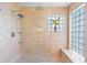 Elegant walk-in shower with patterned floor, glass block window, and dual shower heads at 9016 Bay Ne St, St Petersburg, FL 33702