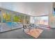 Enclosed sun room with views of pool area, outdoor seating, and lush greenery at 9016 Bay Ne St, St Petersburg, FL 33702