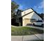 Well-maintained two-story home with a two car garage and a neatly kept lawn at 9067 Cypress Trl, Seminole, FL 33777