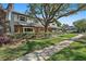 Charming two-story home with mature trees, well-manicured lawn, and beautiful landscaping at 9067 Cypress Trl, Seminole, FL 33777