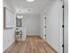 Bright hallway showcasing hardwood floors and neutral wall paint at 9067 Cypress Trl, Seminole, FL 33777