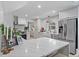 Modern kitchen features white cabinetry, stainless steel appliances, and a quartz countertop island at 9067 Cypress Trl, Seminole, FL 33777