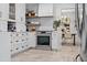 Modern kitchen with white cabinets, stainless steel appliances, and view to the dining room at 9067 Cypress Trl, Seminole, FL 33777