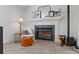 Cozy fireplace with mantel decor, a sitting chair, and neutral tile floors at 9067 Cypress Trl, Seminole, FL 33777