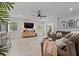 Living room with modern entertainment center, comfortable sofa, and plenty of natural light at 9067 Cypress Trl, Seminole, FL 33777