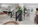 Open concept living and dining area with fireplace, foosball table, stairs, and views to the kitchen at 9067 Cypress Trl, Seminole, FL 33777
