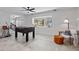 Living room featuring a foosball table, a window seat, and view to the entry at 9067 Cypress Trl, Seminole, FL 33777