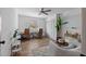 Bright living room features modern furnishings, wood floors, a large window, and potted plants at 9067 Cypress Trl, Seminole, FL 33777