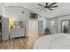Spacious main bedroom featuring laminate floors, a TV, and an ensuite bathroom at 9067 Cypress Trl, Seminole, FL 33777